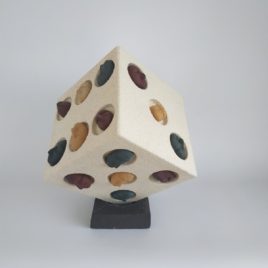 white ceramic dice on a black ceramic base